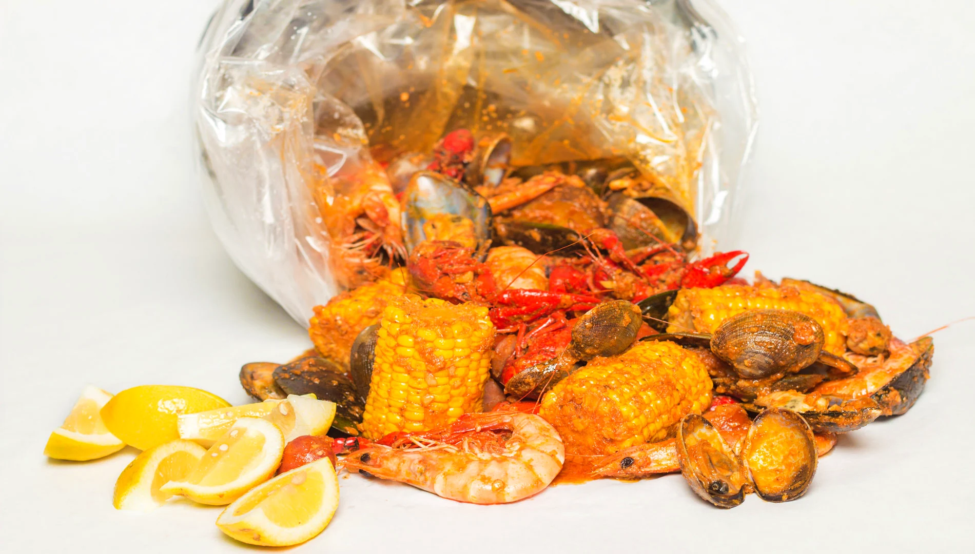 CLAWS seafood boil with crab, shrimp, mussels, corn, potatoes, and sausage